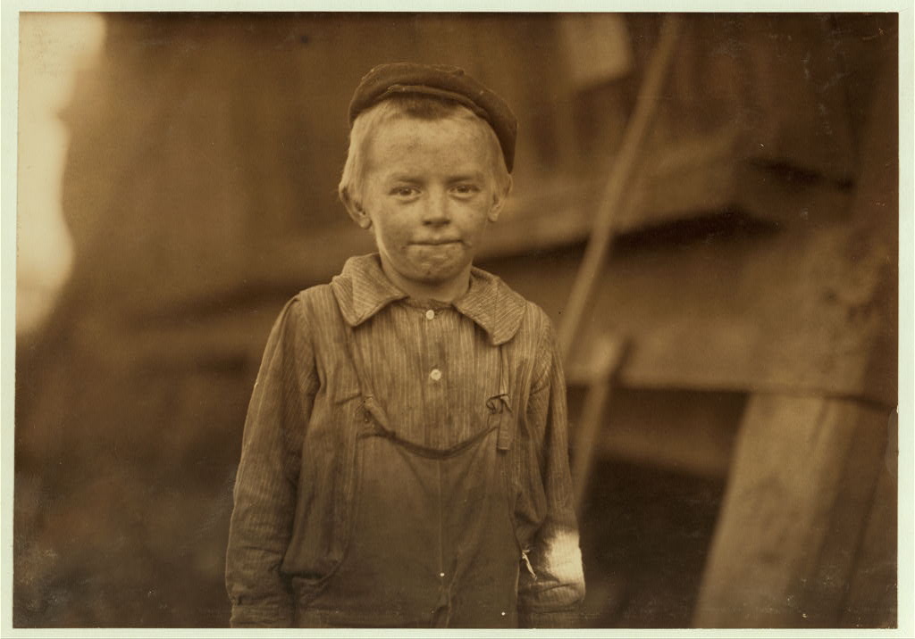 "OUR BABY DOFFER" they called him. Donnie Cole. Has been doffing for some months. When asked his age, he hesitated, then said, "I'm Twelve." Another young boy said "He can't work unless he's twelve." Child Labor regulations were conspicuously posted in the mill. Location: Birmingham, Alabama.