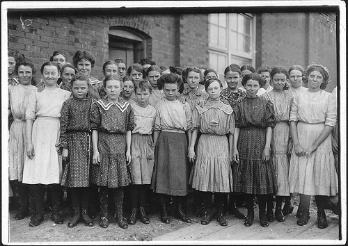 Some of the spinners at Pell City Cotton Mill, grouped by the Overseer, Mr. E. A. Thompson, Supt. of the MIll is also the Mayor of Pell City Photo by Lewis Hines