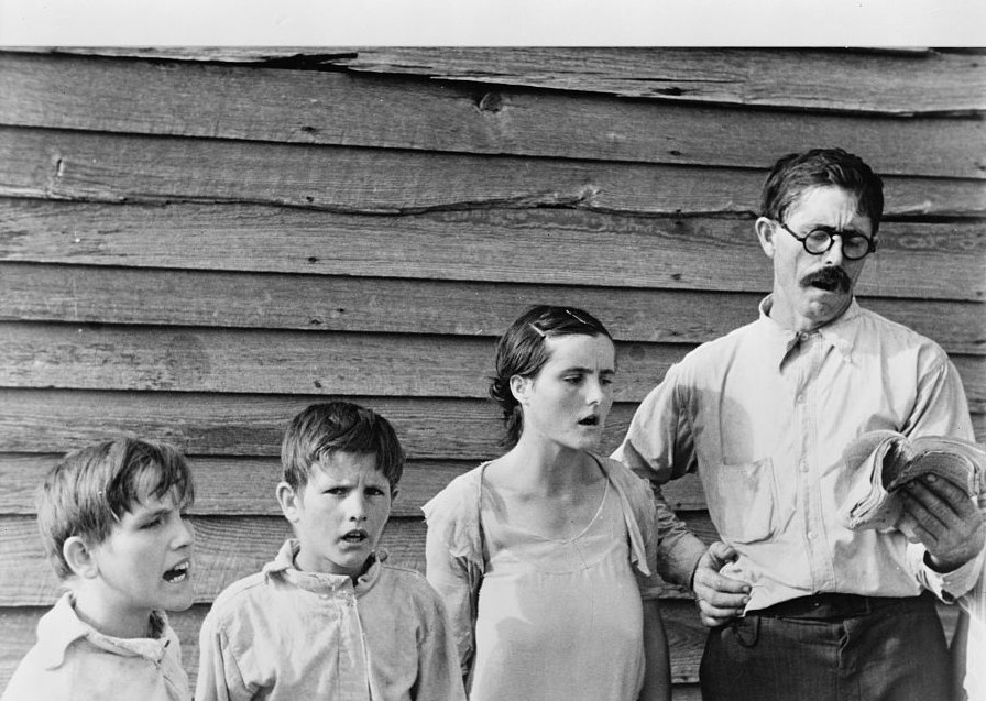 Frank Tengle, an Alabama sharecropper, and family singing hymns. by Photograher Walker Evans