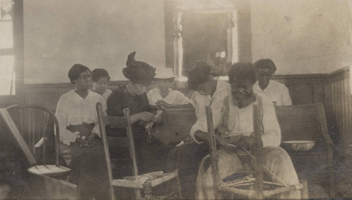 Elderly_African_American_man_showing_teachers_how_to_cane_a_chair_in_a_wooden_church_building_in_Clayton_Alabama