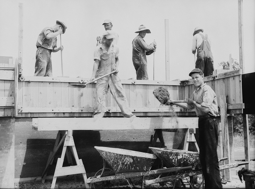 Rammed earth construction near Birmingham, Alabama. After each three-inch layer has been tamped, another layer is spread in the form and work resumed