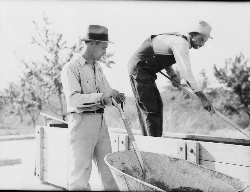 Rammed earth construction near Birmingham, Alabama. The prepared earth is spread in the wall form in layers of three inches in depth