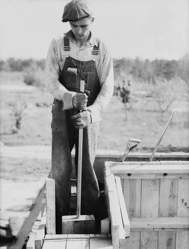 Rammed earth construction near Birmingham, Alabama. The workmen stand in the forms and knead the loose earth with tampers Thomas Hibben