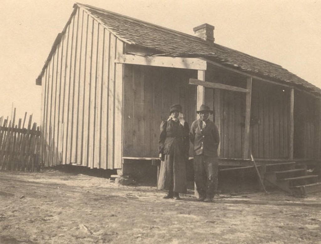 African American man and woman standing in front of a cabin in Crawford, Alabama Q5587