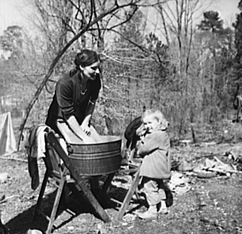 Washing clothes in a migrant camp near Birmingham, Alabama (Library of Congress)